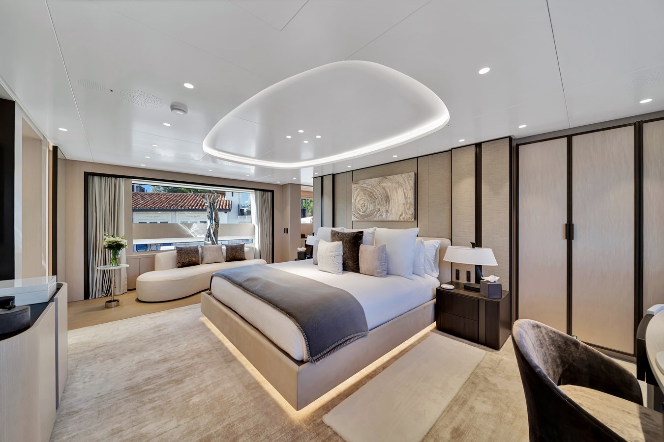 Spacious cabin aboard Jules with a double bed, seating and large windows